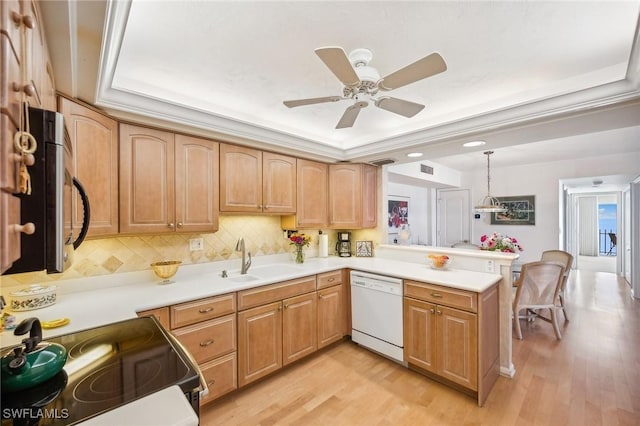 kitchen with sink, electric range oven, kitchen peninsula, dishwasher, and pendant lighting