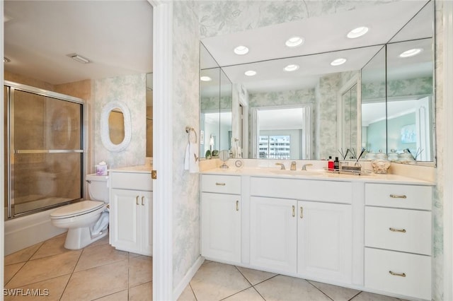 bathroom featuring toilet, vanity, tile patterned floors, and walk in shower