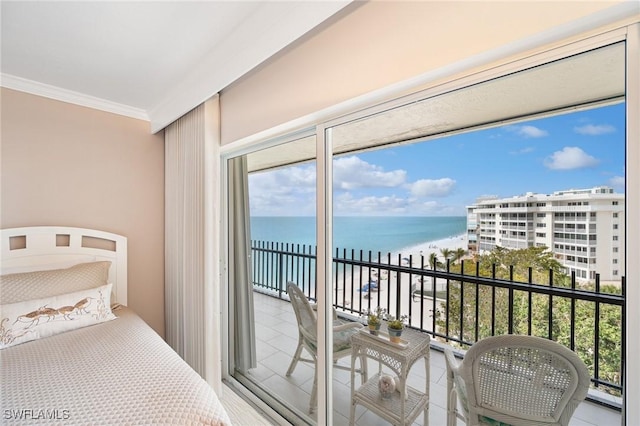 bedroom featuring ornamental molding, a water view, access to exterior, and a view of the beach