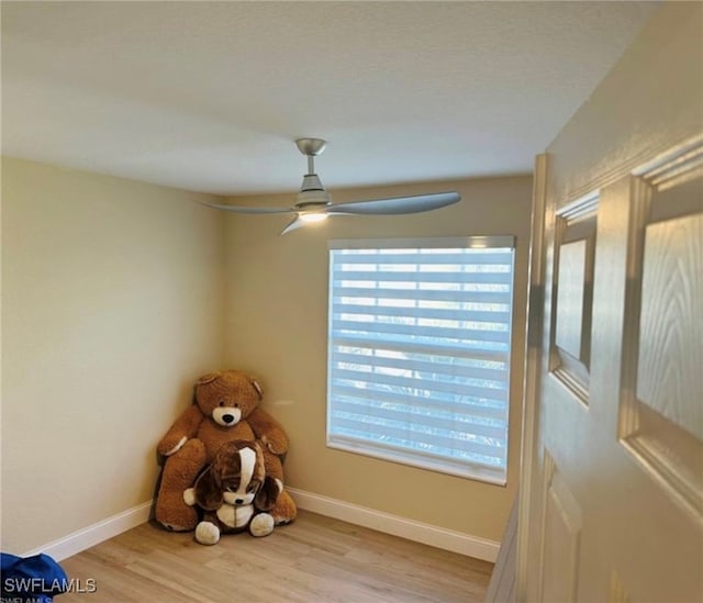 interior space with ceiling fan and light hardwood / wood-style floors