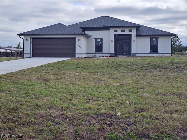 view of front of home featuring a garage and a front lawn