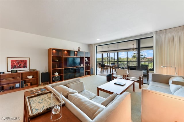 carpeted living room featuring expansive windows