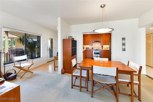 dining space with light wood-type flooring