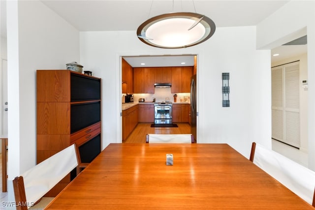 dining space with light wood-type flooring