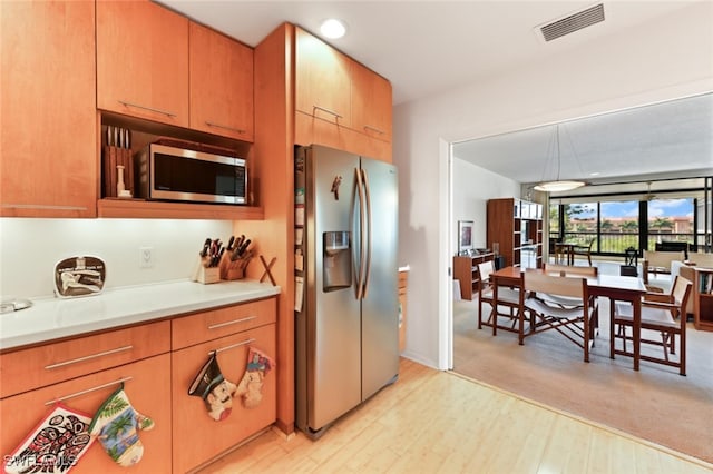 kitchen featuring light hardwood / wood-style flooring and stainless steel appliances