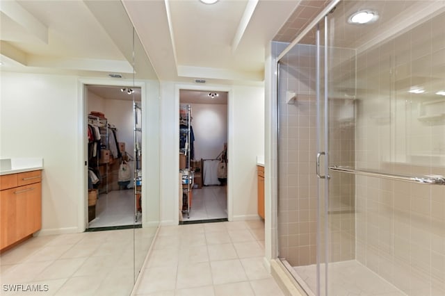 bathroom featuring vanity, tile patterned floors, and walk in shower