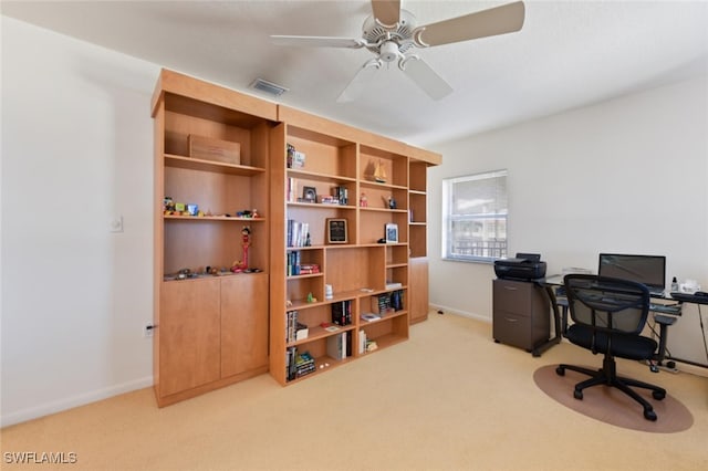 home office featuring light colored carpet and ceiling fan