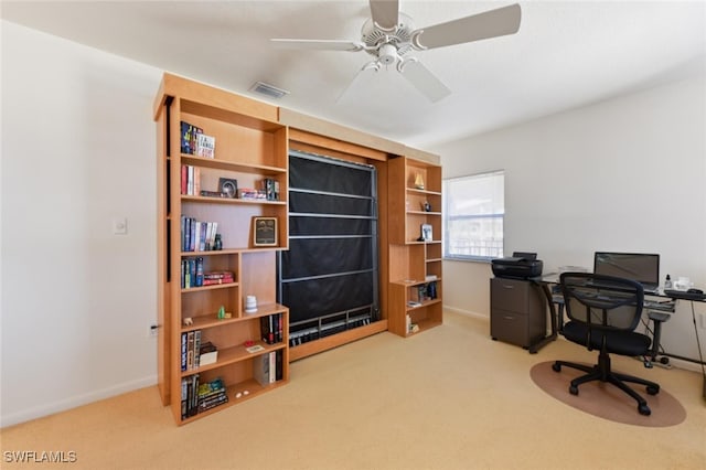 office space with ceiling fan and light carpet