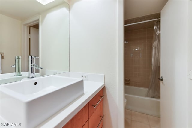 bathroom with shower / bath combo, tile patterned flooring, and vanity