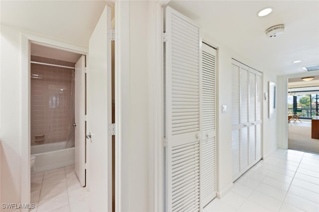 hall with light tile patterned floors