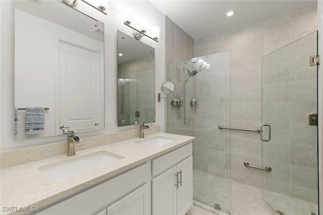 bathroom featuring vanity and a shower with door