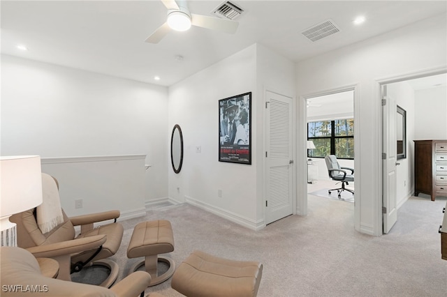 sitting room featuring ceiling fan and light colored carpet