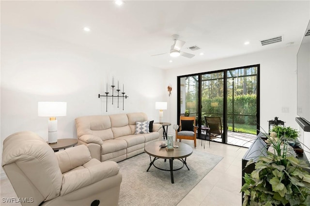 living room featuring light tile patterned flooring and ceiling fan