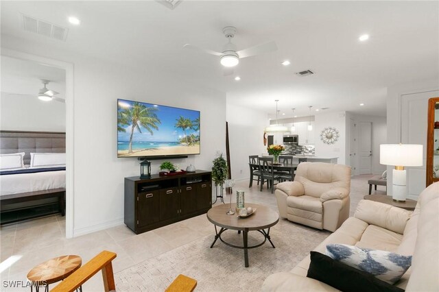 tiled living room featuring ceiling fan