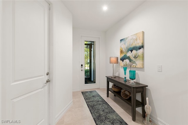 doorway with light tile patterned floors