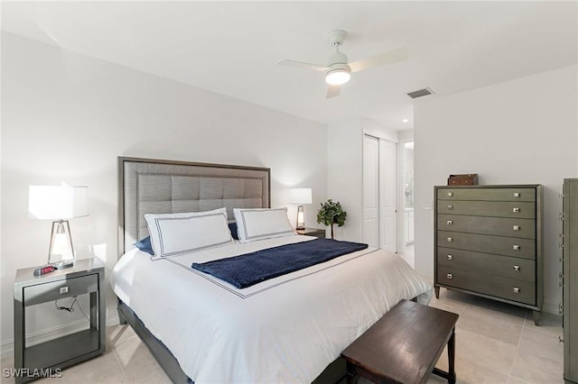 bedroom featuring light tile patterned flooring, ceiling fan, and a closet