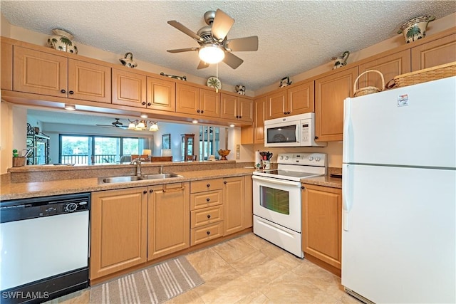 kitchen with white appliances, a sink, light brown cabinetry, and ceiling fan