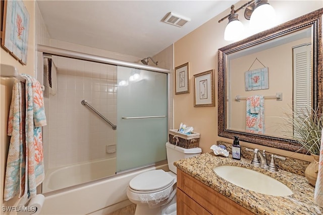 full bathroom featuring visible vents, toilet, vanity, and shower / bath combination with glass door