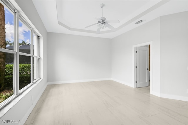 unfurnished room featuring a tray ceiling and ceiling fan