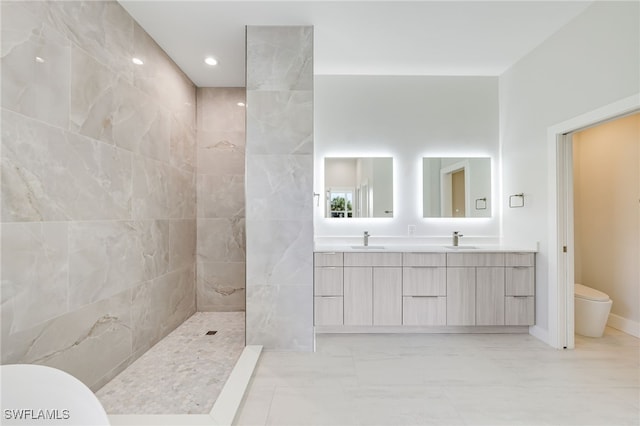 bathroom with toilet, a tile shower, and vanity