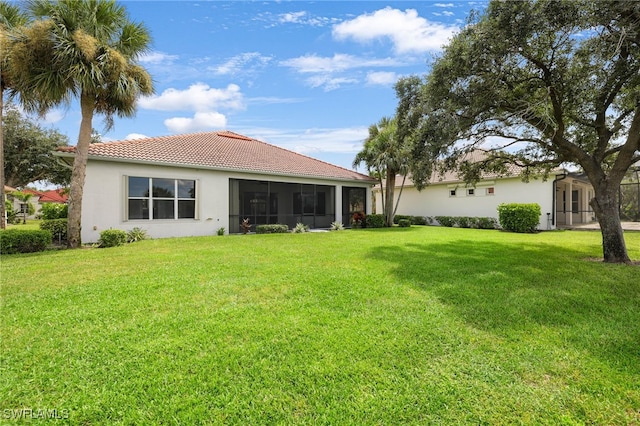 rear view of property with a yard