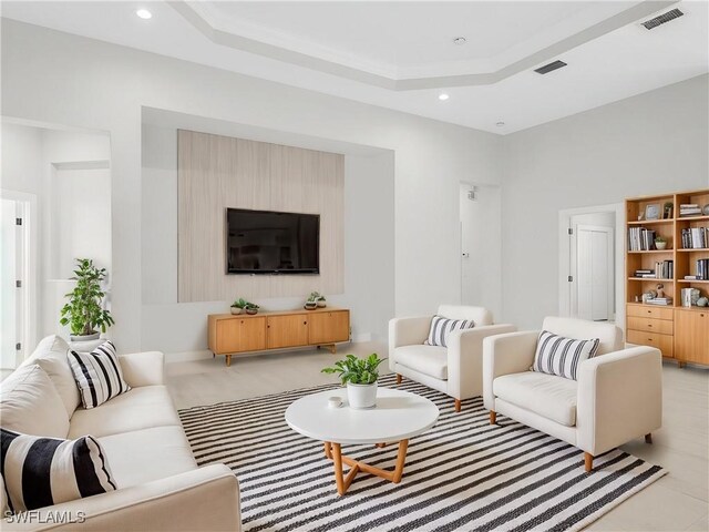 living room featuring a raised ceiling