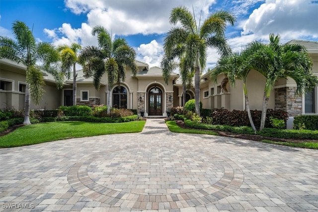 mediterranean / spanish-style home with a front yard