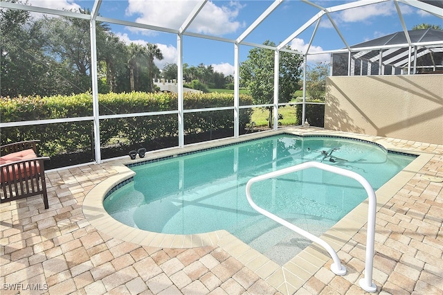 view of swimming pool with a patio and glass enclosure