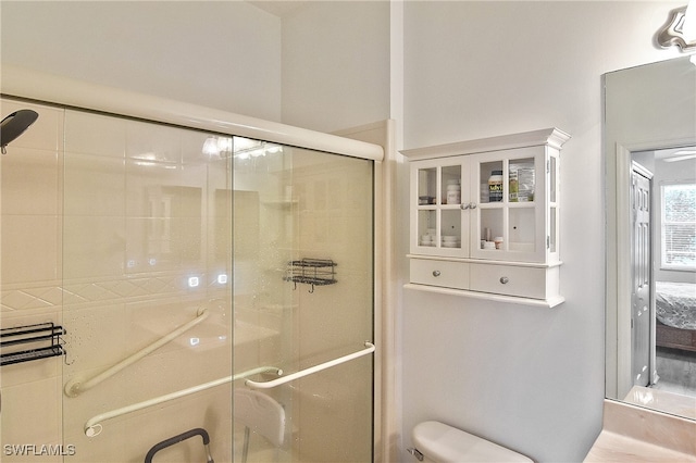 bathroom featuring toilet and an enclosed shower