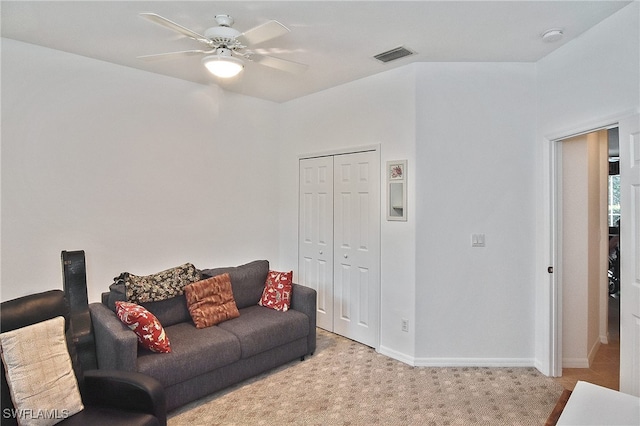 carpeted living room with ceiling fan