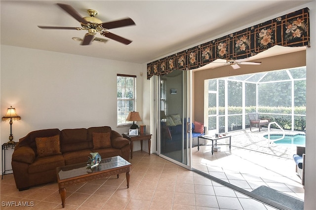 living room with ceiling fan and light tile patterned flooring