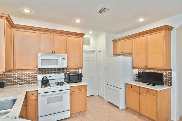 kitchen featuring white appliances, light tile patterned flooring, and tasteful backsplash