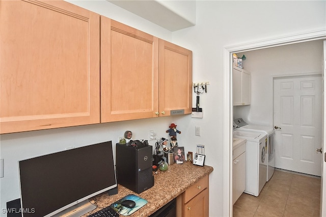 laundry room featuring washing machine and clothes dryer, cabinets, and light tile patterned floors