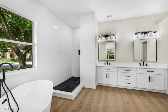 bathroom with vanity, wood-type flooring, and shower with separate bathtub