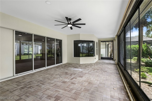 unfurnished sunroom with ceiling fan and a healthy amount of sunlight