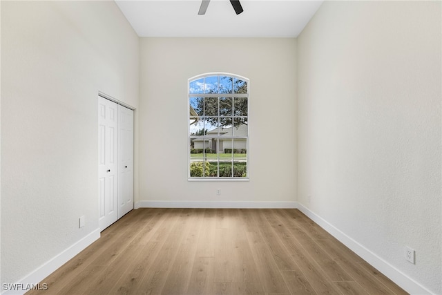 empty room featuring ceiling fan and light hardwood / wood-style flooring