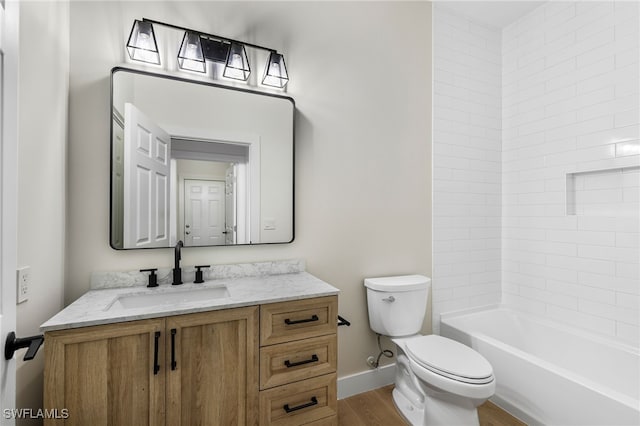 full bathroom with washtub / shower combination, vanity, toilet, and hardwood / wood-style floors