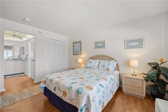 bedroom featuring light wood-type flooring, connected bathroom, and a closet