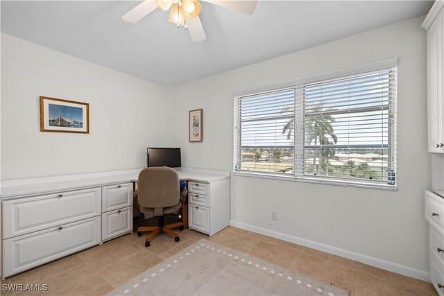 tiled home office with plenty of natural light and ceiling fan