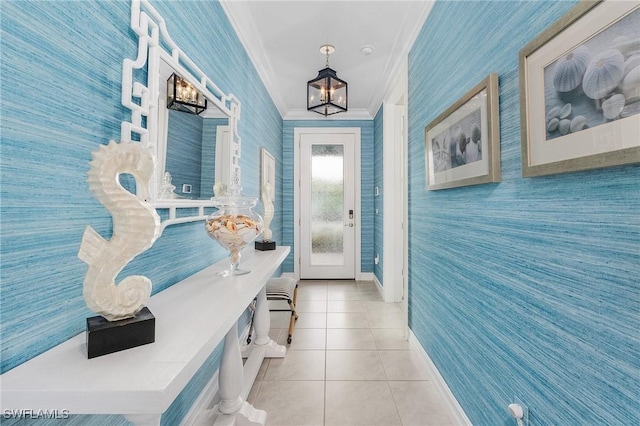 mudroom featuring crown molding, light tile patterned floors, a chandelier, baseboards, and wallpapered walls