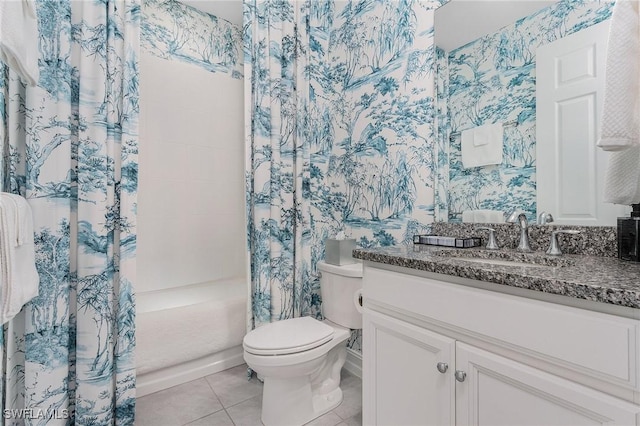 bathroom featuring toilet, vanity, a shower with curtain, baseboards, and tile patterned floors