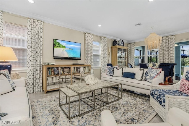 living area with ornamental molding, recessed lighting, visible vents, and an inviting chandelier