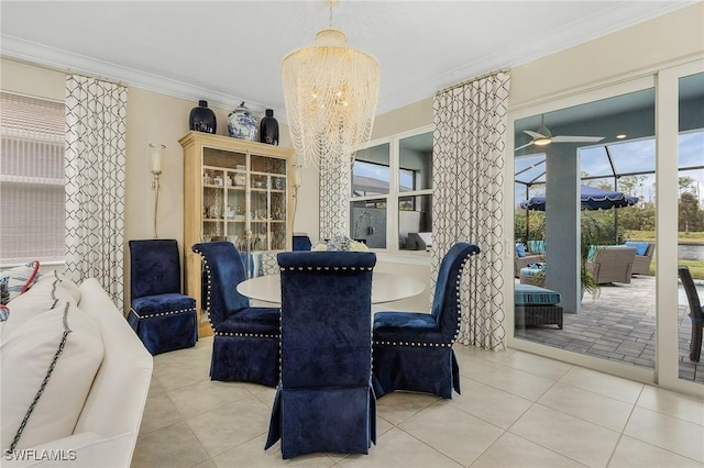 tiled dining area featuring crown molding and ceiling fan with notable chandelier