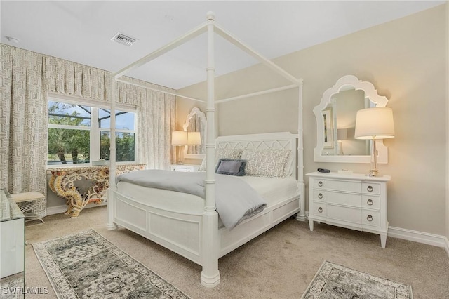 bedroom with light carpet, visible vents, and baseboards