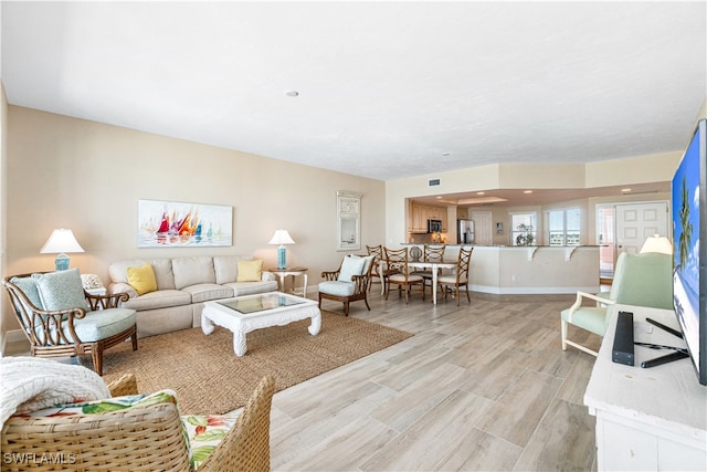 living room with light hardwood / wood-style flooring