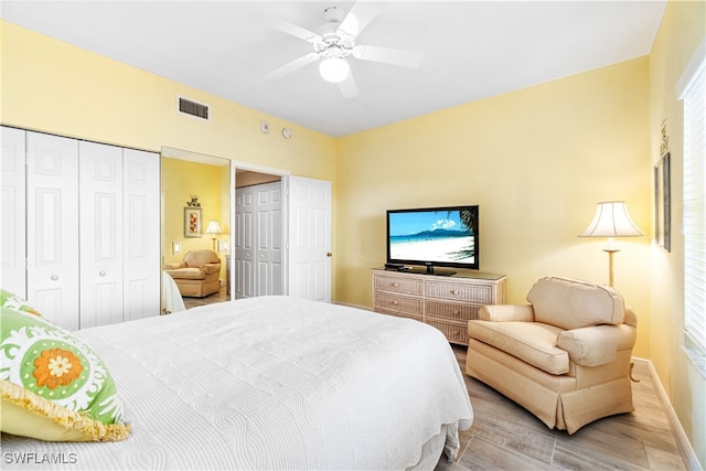 bedroom with multiple windows, a closet, ceiling fan, and light hardwood / wood-style floors