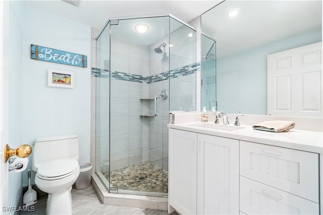 bathroom with an enclosed shower, tile patterned flooring, toilet, and vanity