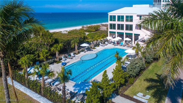 birds eye view of property featuring a water view and a view of the beach