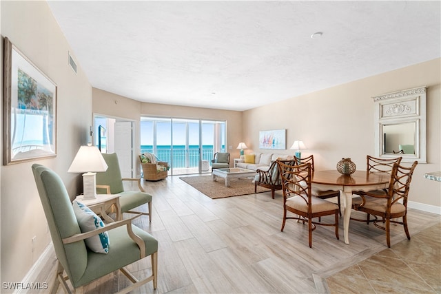 interior space featuring a water view and light hardwood / wood-style flooring