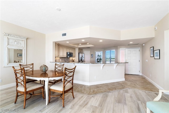 dining area featuring a tray ceiling